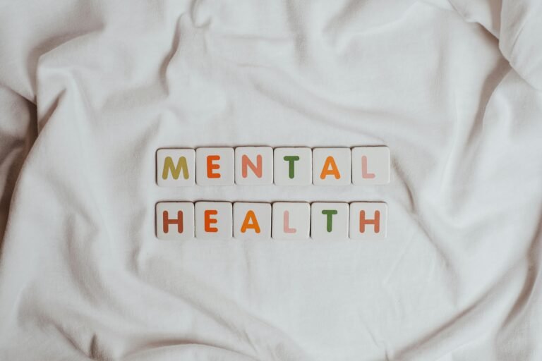 Close-up of 'Mental Health' text on cloth, symbolizing calmness and self-care.